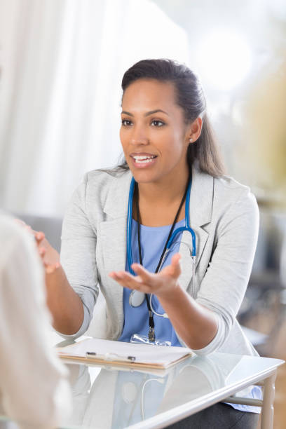 istock Serious healthcare gestures while talking with unrecognizable patient 865900246