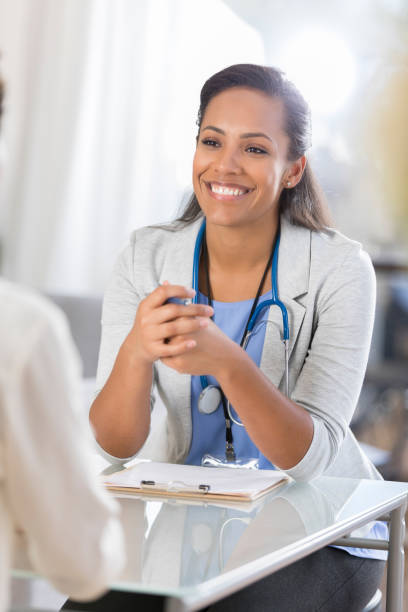 istock Cheerful doctor talks with unrecognizable patient 865900256