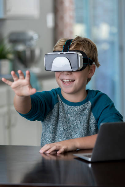 istock Happy preteen boy using virtual reality goggles 865900368