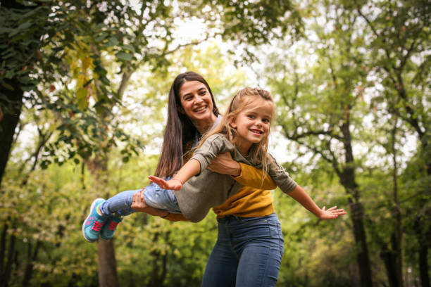 istock Daughter fly in Moms arms. 865900448