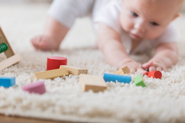istock Wood blocks are intriguing and baby reaches for them 865902726