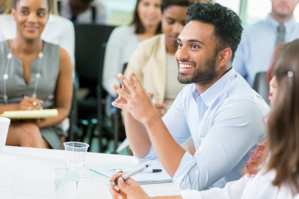 istock Cheerful businessman participates in panel discussion during seminar 865902976
