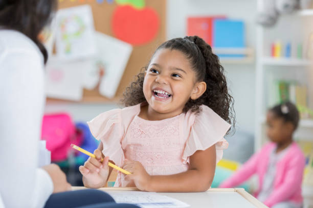 istock Happy toddler enjoys drawing in daycare classroom 865903170