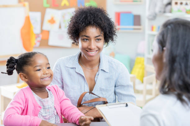 istock African American mom talks with teacher during conference 865903238