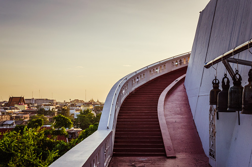 Long red stairs to Golden Mountain in Thailand, with sunset on the background