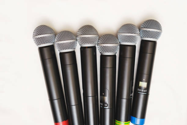 istock Top view of six black wireless professional microphones. 865910626
