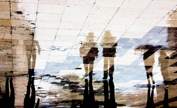 istock Reflection silhouette of people in the rain 865915196