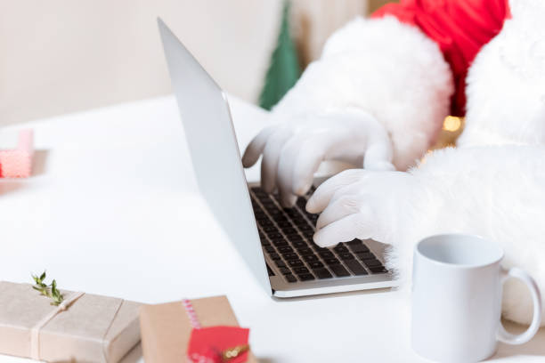 istock santa claus typing on laptop 865919576