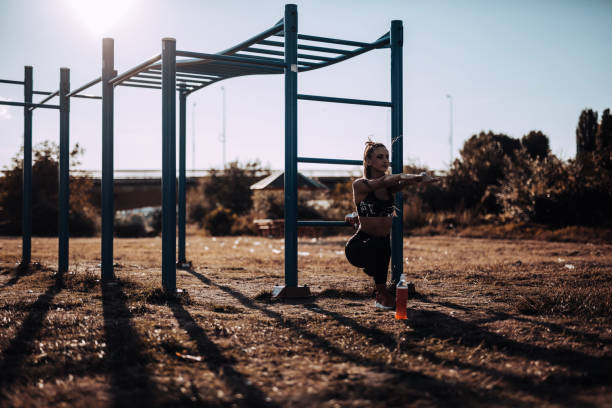 istock Woman doing squat exercise outdoors 865919658