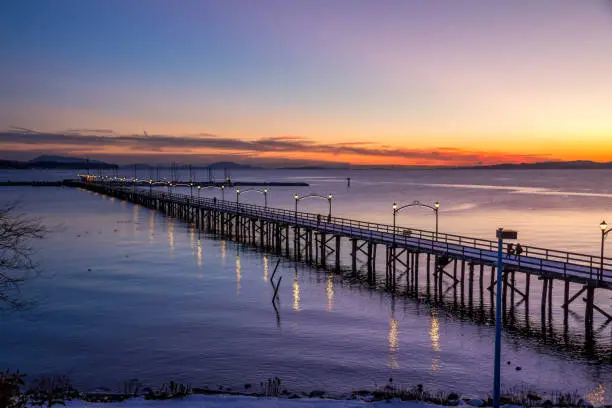 Photo of White Rock pier during a sunset in winter.  BC, Canada
