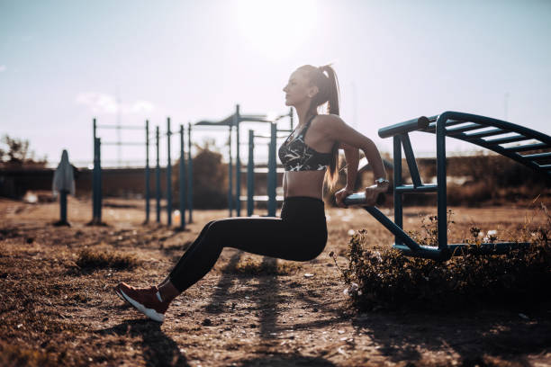 istock Young woman doing push ups outdoors 865920106