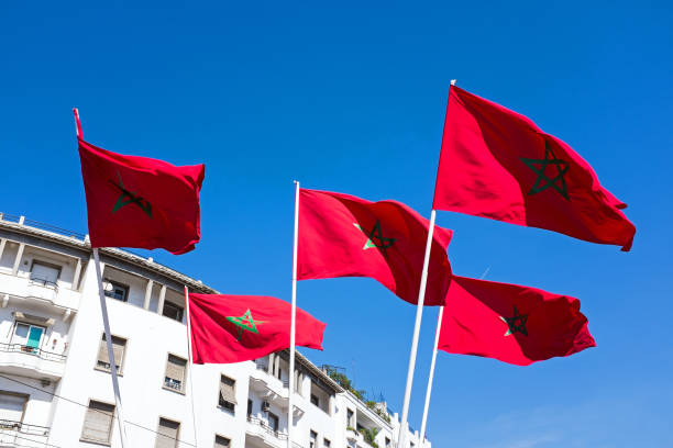 istock Moroccan flags against a blue sky in Morocco 865922860