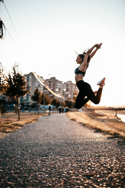 istock Young woman jumping and celebrating 865924400