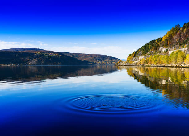 istock Horizontal vivid Norway day river water circles drops background 865924620