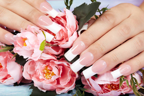 istock Hands with beautiful long artificial french manicured nails 865928624