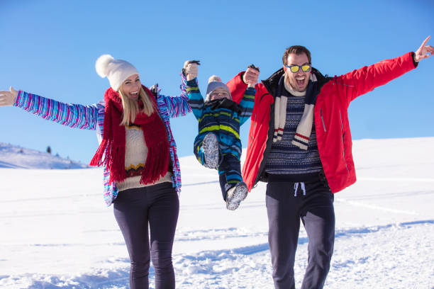 istock Attractive family having fun in a winter park on mountain 865944198