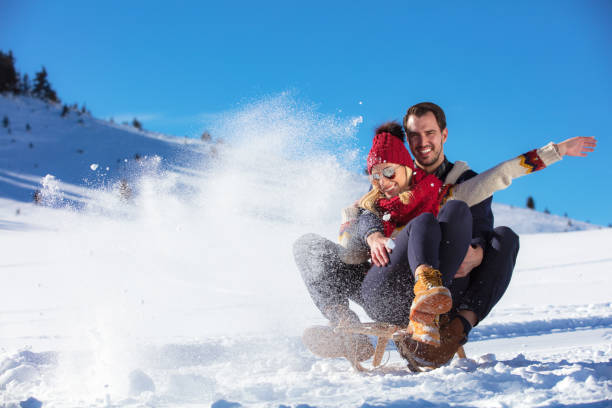istock Young Couple Sledding And Enjoying On Sunny Winter Day 865944464