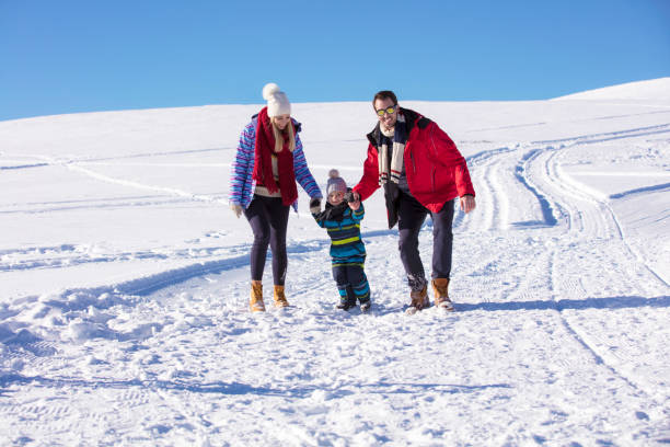 istock Attractive family having fun in a winter park on mountain 865946898