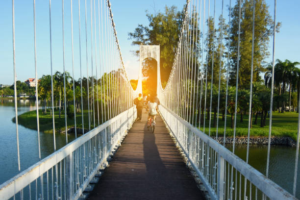 istock People on the bridge at public park in evening 865950378