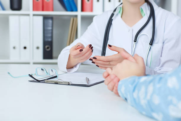 istock Doctor and patient are discussing something, just hands at the table. 865952422