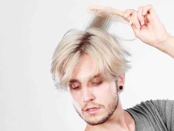 istock Man with stylish haircut combing his hair 865952518