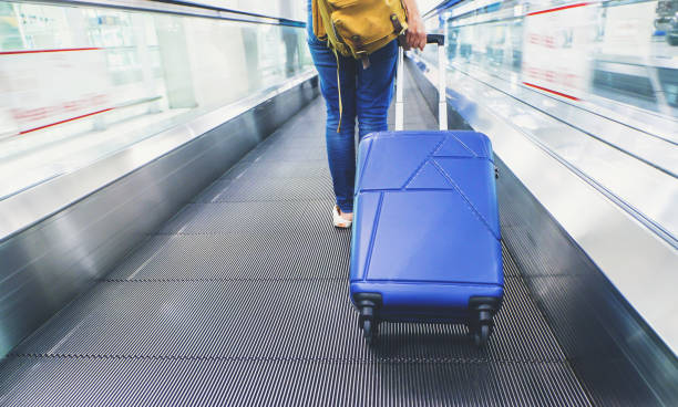 istock Traveler pull suitcase walking on express way at airport with motion blur effect,Travel concept 865952890