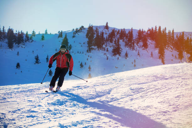 istock Skier skiing downhill in high mountains against sunset 865955914