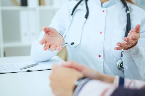 istock Doctor and patient are discussing something, just hands at the table. 865955996