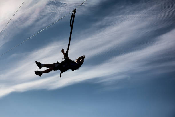 istock Child zip lines over a beautiful sky 865956202