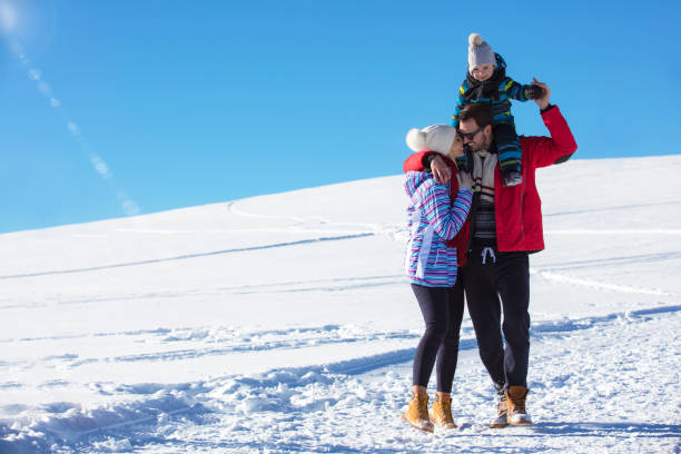 istock Attractive family having fun in a winter park on mountain 865961506