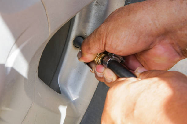 istock Pumping air filling air into a car tire. 865965680