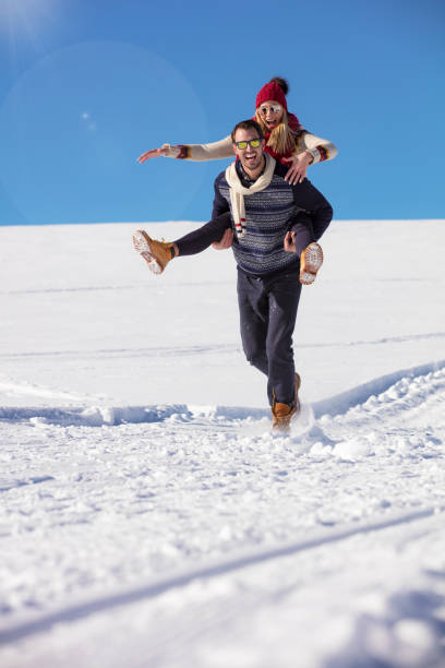 istock Loving couple playing together in snow outdoor. 865965732