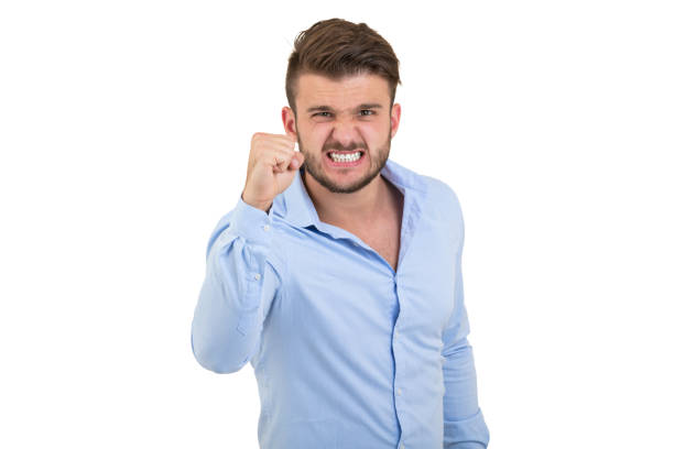 Image of screaming angry young bearded emotional man standing over white wall background isolated