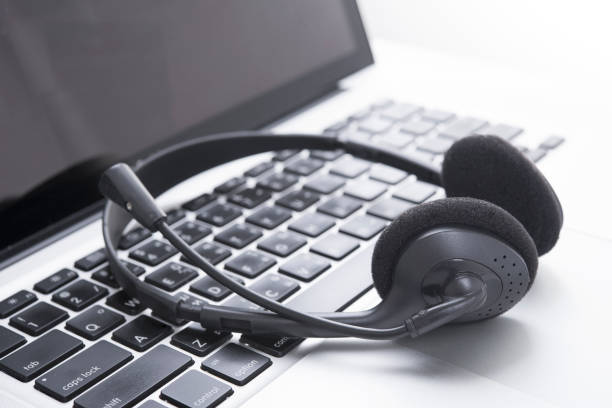 istock headset and computer laptop, call center support and customer service help, concept for communication 865967654