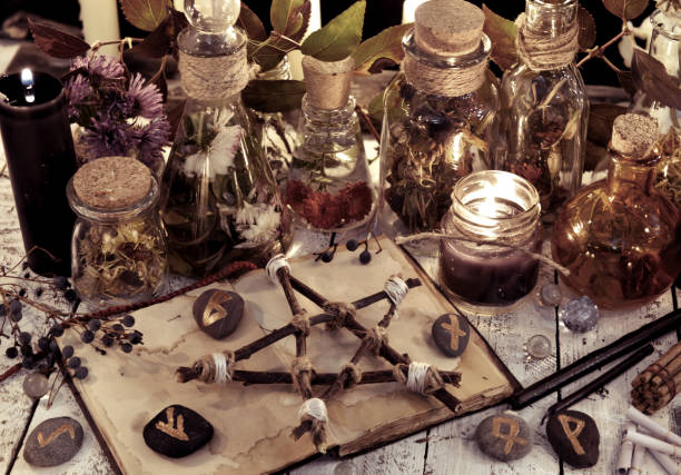 istock Potion bottles, wooden pentagram, black candles and magic objects 865970462