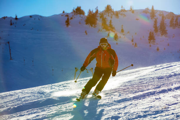 istock Skier skiing downhill in high mountains against sunset 865973200