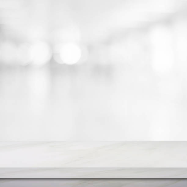 istock Empty white marble table over blur store background, product and food display montage 865976708
