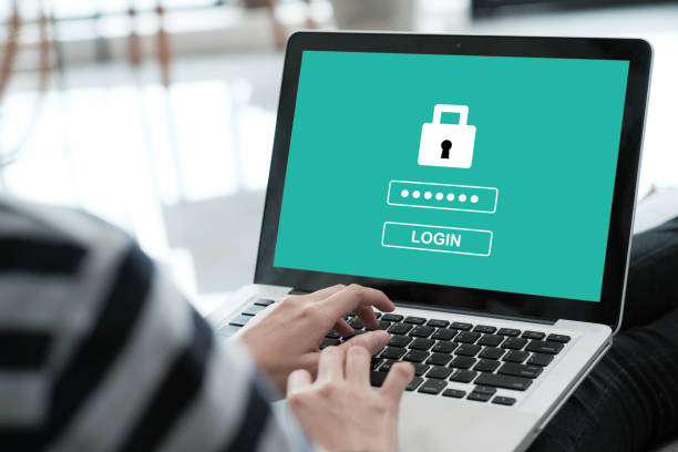 Hand tying laptop computer with password login on screen, cyber security concept