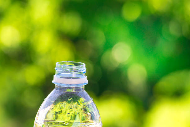 istock Bottle water made to plastic on sky and tree blurry background.Using wallpaper for package or product, refreshing image and copy space. 865979482