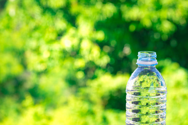istock Bottle water made to plastic on sky and tree blurry background.Using wallpaper for package or product, refreshing image and copy space. 865979488
