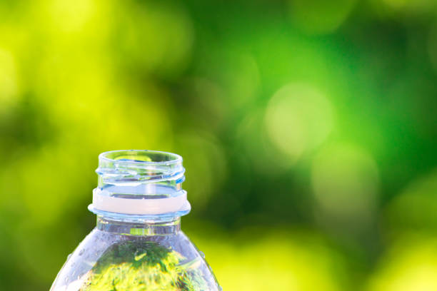istock Bottle water made to plastic on sky and tree blurry background.Using wallpaper for package or product, refreshing image and copy space. 865979490