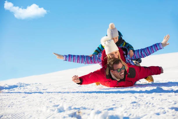 ski, snow sun and fun - happy family on ski holiday - family skiing ski vacations imagens e fotografias de stock