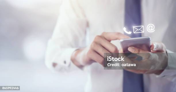 Contact Us Hand Of Businessman Holding Mobile Smartphone With Stock Photo - Download Image Now