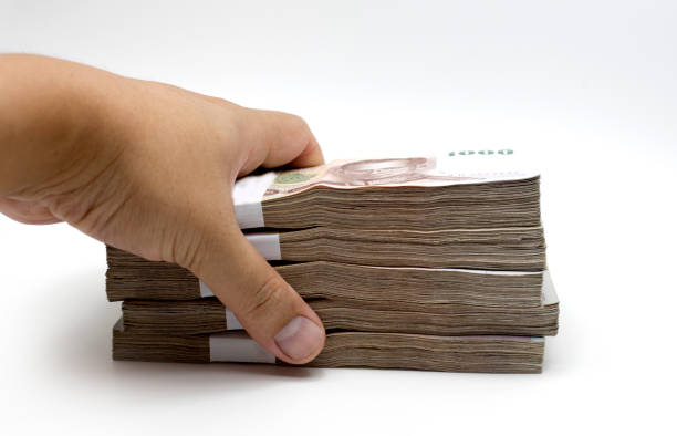 istock hand steal thai baht money note on white 865994046