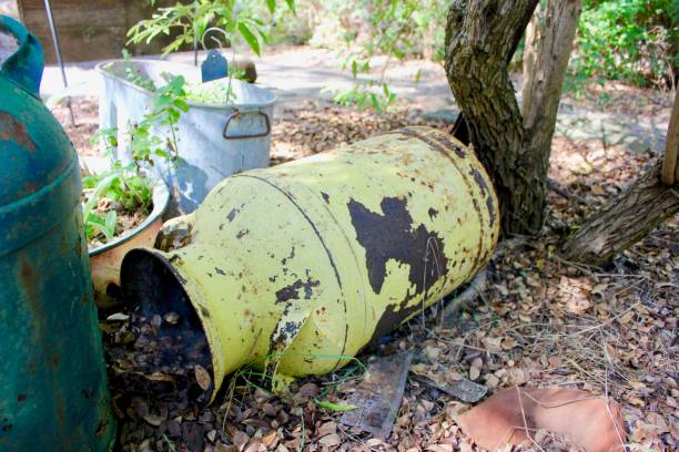 istock Rusty yellow farm jug used as a planter 865999774