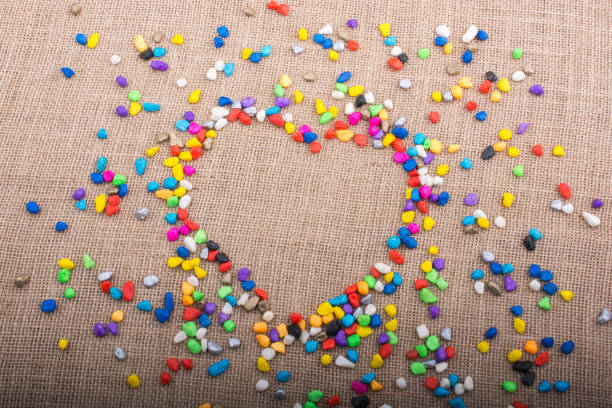 istock Colorful pebbles form a heart shape on canvas ground 866001732
