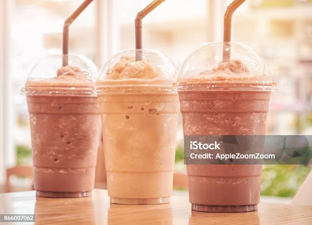Chocolate Frappe And Frappuccino On Wood Table Stock Photo - Download Image Now - Coffee Frappe, Chocolate, Whip - Equipment