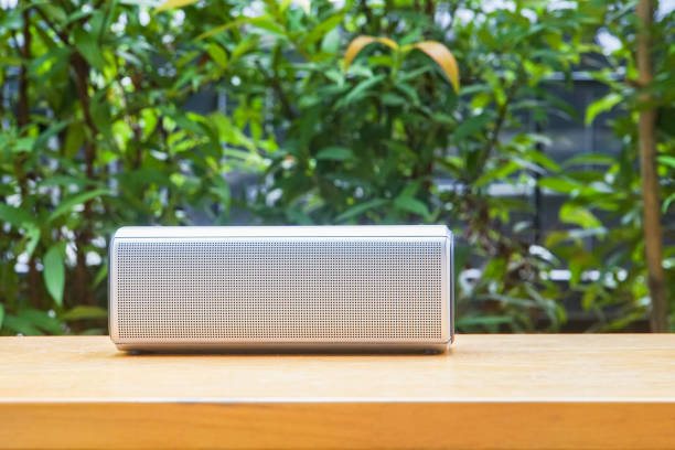 istock portable Bluetooth wireless music speaker on wooden table in the park 866007470
