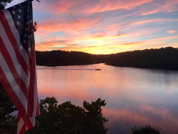 Sunset on lake with fishing boat