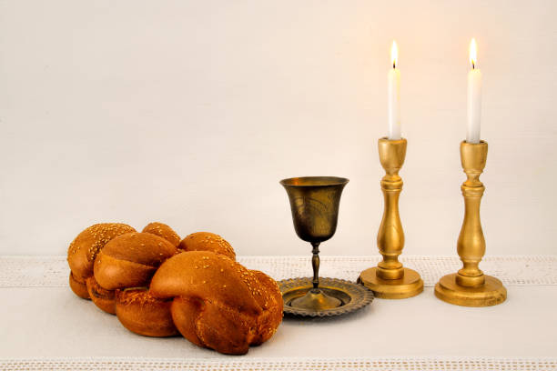 istock shabbat image. challah bread, shabbat wine and candles on the table 866017746